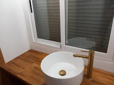 a white toilet in a bathroom with a window at The Villarosa in Turís