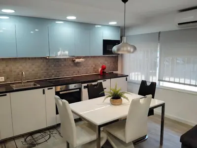 a kitchen with a table and chairs in a room at Apartamento Plaza Palmeras in Burjasot