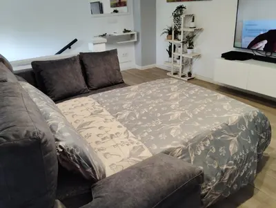 a couch with a blanket on it in a living room at Apartamento Plaza Palmeras in Burjasot