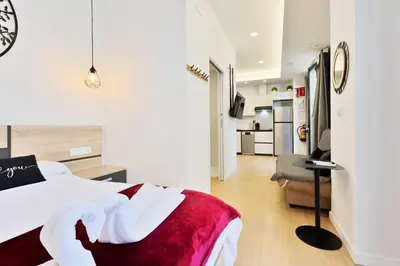 a bedroom with a bed and a living room at Apartamento RD A in Valencia