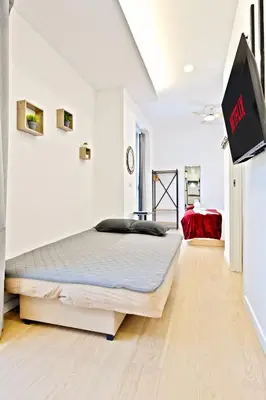 a bedroom with a large bed in a white room at Apartamento RD A in Valencia