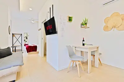 a white living room with a table and a couch at Apartamento RD A in Valencia