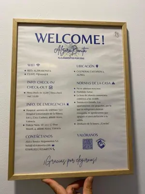 a person holding up a sign with a welcome menu at ALZIRA BONiTA LES BARRAQUES 2PAX in Alzira