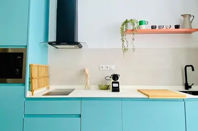 a kitchen with blue cabinets and a white counter top at BAJO C - Design & Comfort in Ruzafa SOHO in Valencia