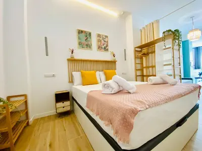 a bedroom with a large bed with towels on it at BAJO C - Design & Comfort in Ruzafa SOHO in Valencia