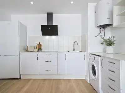 a white kitchen with a sink and a dishwasher at Estudio Temporal a 2' de la playa de Sagunto A2 in Puerto de Sagunto