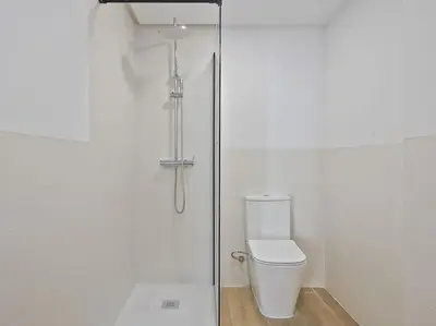 a bathroom with a toilet and a glass shower at Moderno estudio a 2 minutos de la Playa Sagunto A3 in Puerto de Sagunto