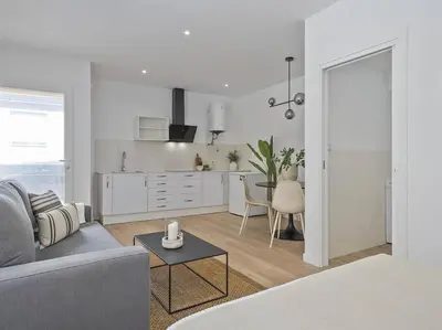 a white living room with a couch and a table at Refugio Costero a 2 minutos de Playa Sagunto A4 in Puerto de Sagunto