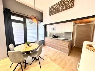 a kitchen and dining room with a table and chairs at Place Your Place SUITES Benimaclet in Valencia