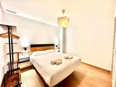 a bedroom with a bed with two towels on it at Place Your Place SUITES Benimaclet in Valencia