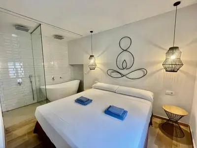 a bedroom with a large bed and a bath tub at ESTUDIO CON JACCUZI Y SAUNA montaña y playa in Tavernes de Valldigna