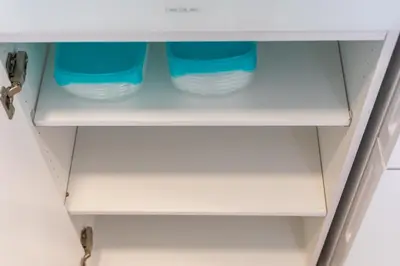 a cupboard with blue glasses in it at UrbanNest Apartment in Valencia