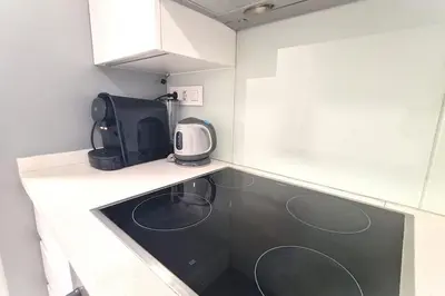 a kitchen with a counter top with a microwave at E-Arenas Apartment with terrace in Edificio Arenas in Valencia
