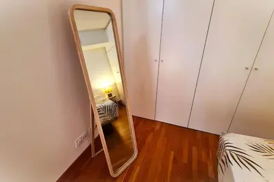 a mirror in a room with a bed at E-Arenas Apartment with terrace in Edificio Arenas in Valencia