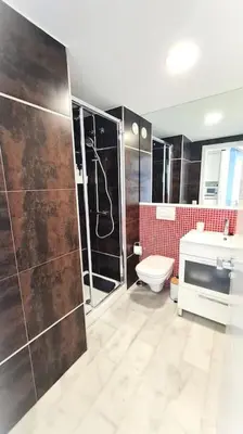 a bathroom with a shower and a toilet and a sink at E-Arenas Apartment with terrace in Edificio Arenas in Valencia