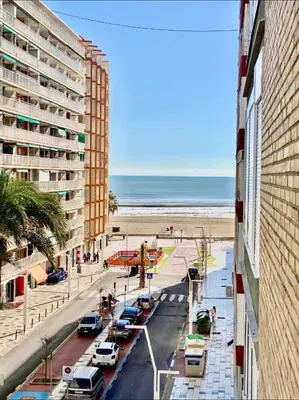 a view of a street with a beach and a building at 100 metros playa con vistas al mar Piso nuevo 2024 in Cullera