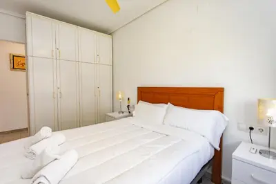 a bedroom with a large white bed with white pillows at Cullera Horizon Apartment in Cullera
