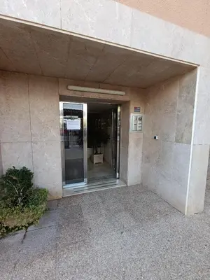 an entrance to a building with a glass door at Luminoso estudio con vistas al mar in Las Canteras