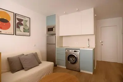 a kitchen with a washing machine in a living room at Luminoso estudio con vistas al mar in Las Canteras