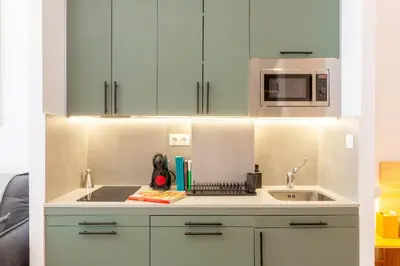 a kitchen with white cabinets and a sink at Nuevo loft cerca del centro y Ciudad Artes y Ciencias in Valencia