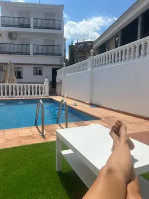 a man laying on a bench next to a swimming pool at El Siprer in Anna