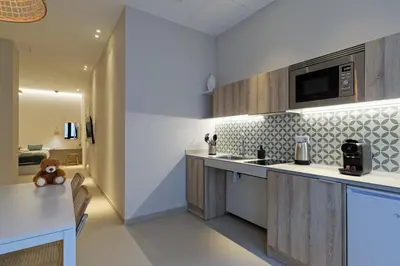 a kitchen with wooden cabinets and a counter top at Osito Hub - Esteban Ballester in Valencia