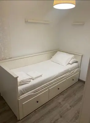 a white bed with white sheets and towels on it at Departamento en Torrent in Torrent
