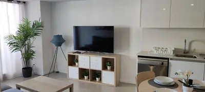 a living room with a flat screen tv on a cabinet at Gran Canet Vlado in Canet de Berenguer