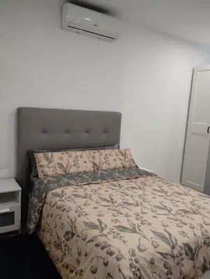 a bedroom with a bed with a comforter at Apartamento Plaza Palmeras2 in Burjasot