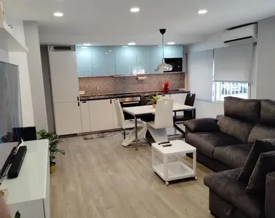 a living room with a couch and a table at Apartamento Plaza Palmeras2 in Burjasot