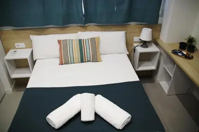 a bedroom with a large bed and a television at Flats Benimaclet in Valencia