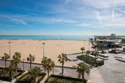 a view of a beach with palm trees and the ocean at Romantic Apartment in Cabanyal by Virkin Suites in Valencia
