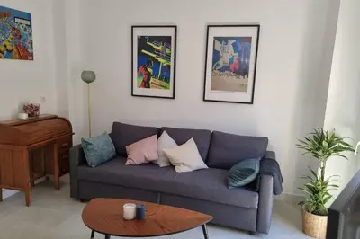 a living room with a couch and a table at Romantic Apartment in Cabanyal by Virkin Suites in Valencia