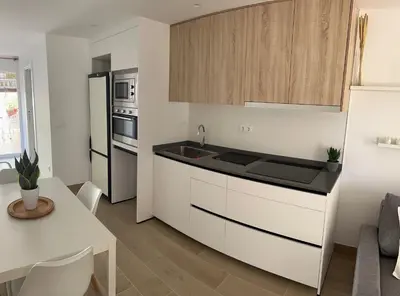 a kitchen with white cabinets and a counter top at vivienda independiente in Canet de Berenguer