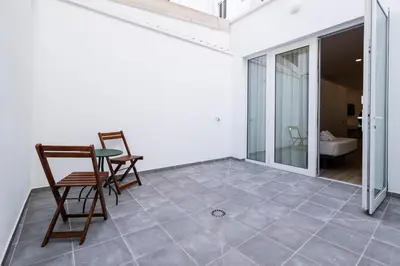 a room with a table and chairs on a tile floor at La casa de la pintora by Concept Flats in Valencia