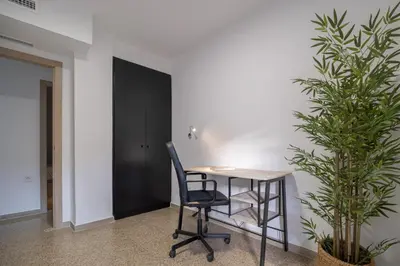 an office with a desk and a chair and a plant at GuestReady - Valencia Bliss near Malvarrosa Beach in Valencia