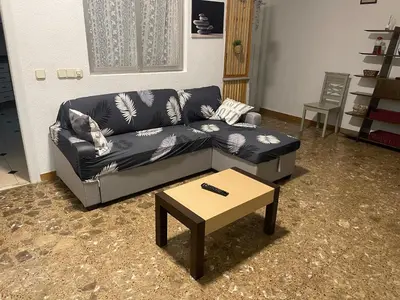 a living room with a couch and a coffee table at Acogedora planta baja in Benaguacil