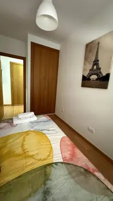 a bedroom with a bed with a picture of the eiffel tower at Apartamentos Felip 3 in Burriana