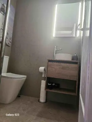 a bathroom with a toilet and a sink and a mirror at Apartments del sol in Cullera