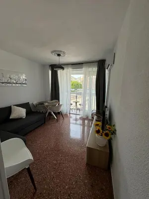 a living room with a couch and a table at Apartments del sol in Cullera