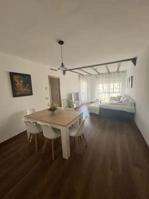 a living room with a table and a bed at Casa Emma in Burriana