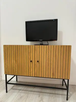 a flat screen tv on top of a wooden cabinet at Anthracita in Valencia