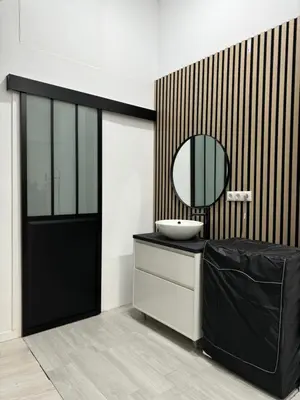 a bathroom with a black door and a mirror at Anthracita in Valencia