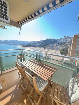 a table and chairs on a balcony with a view of the beach at Seaviews Los Olivos in Cullera