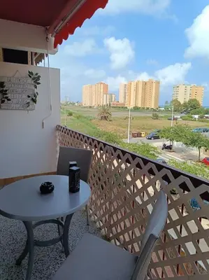 a table and chairs on a balcony with a view at La Llar45 , Relájate junto al mar in Playa Pobla de Farnals
