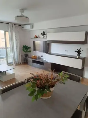 a living room with a table with a potted plant at La Llar45 , Relájate junto al mar in Playa Pobla de Farnals