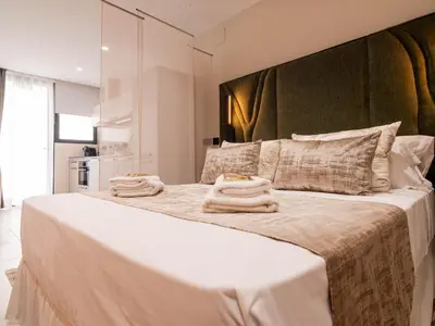 a bedroom with a large bed with towels on it at MD Nou Mestalla in Valencia