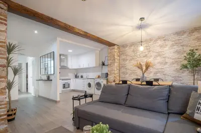 a living room with a couch and a dining room at Apartment in El Mercat in Valencia
