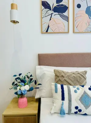 a bedroom with a bed with a vase of flowers at Color & Design next to Russafa SOHO in Valencia