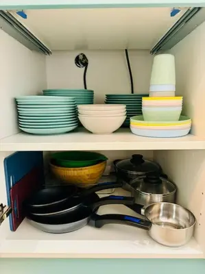 a shelf with plates and bowls and other dishes at Color & Design next to Russafa SOHO in Valencia